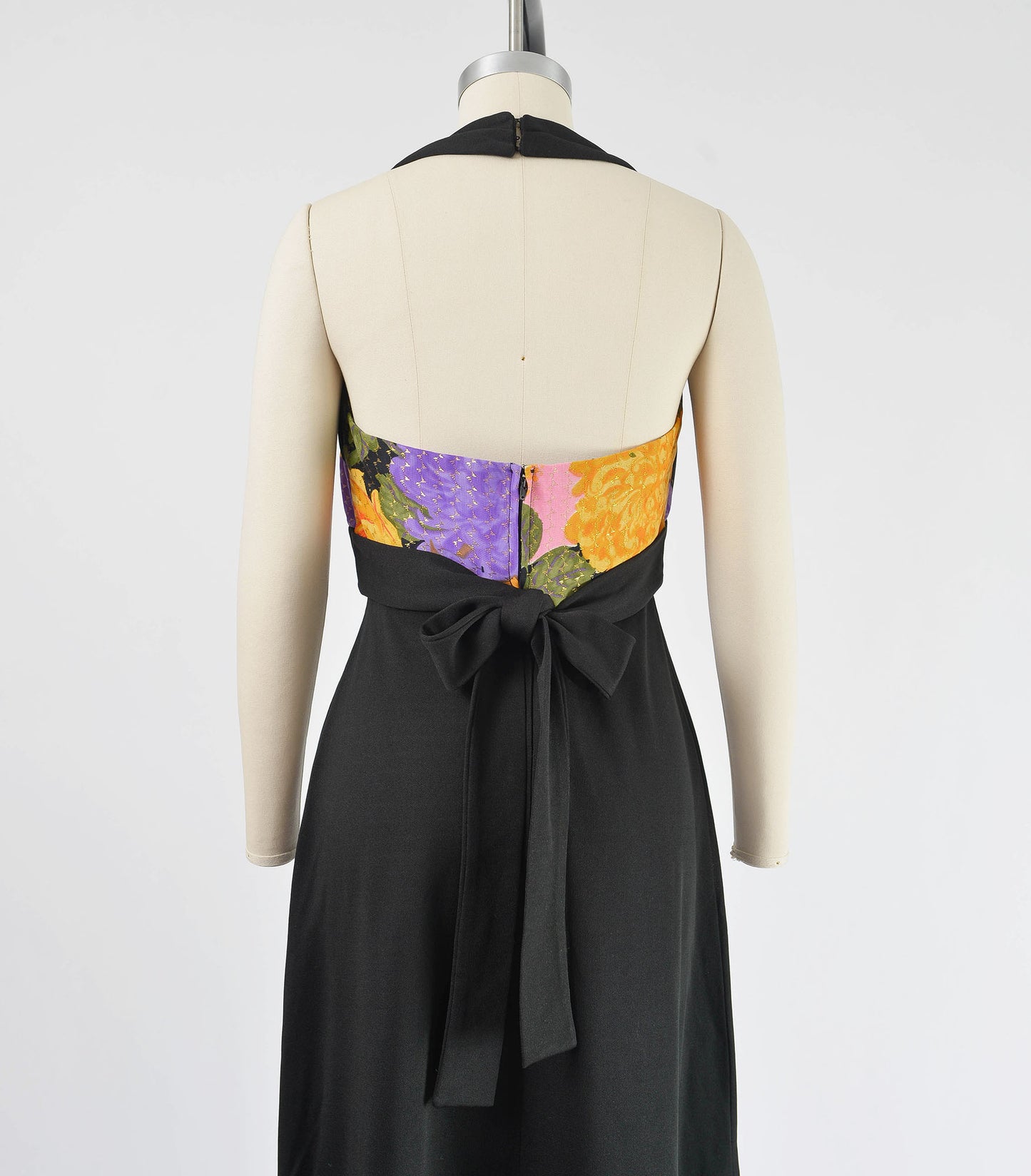 Close up back view of 70s halter maxi dress. The waist ties at the back.
