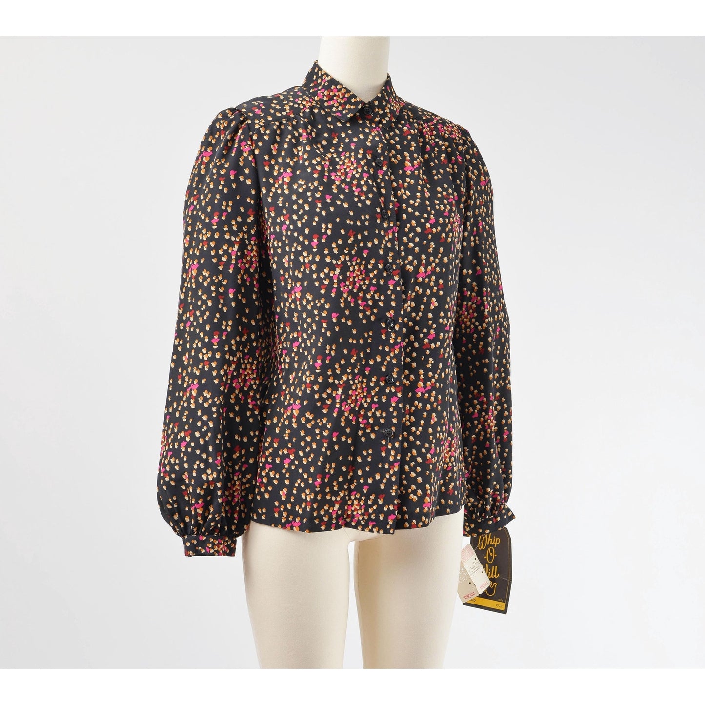 Side view of 70s black spotted blouse. Matte silky fabric. Collared neckline with long puff sleeves.