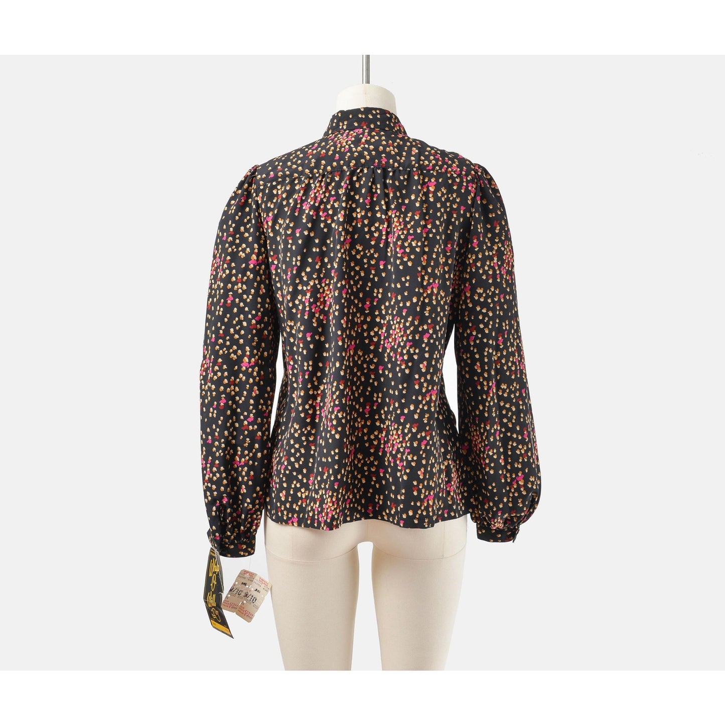 Back view of 70s black spotted blouse. Matte silky fabric. Collared neckline with long puff sleeves.