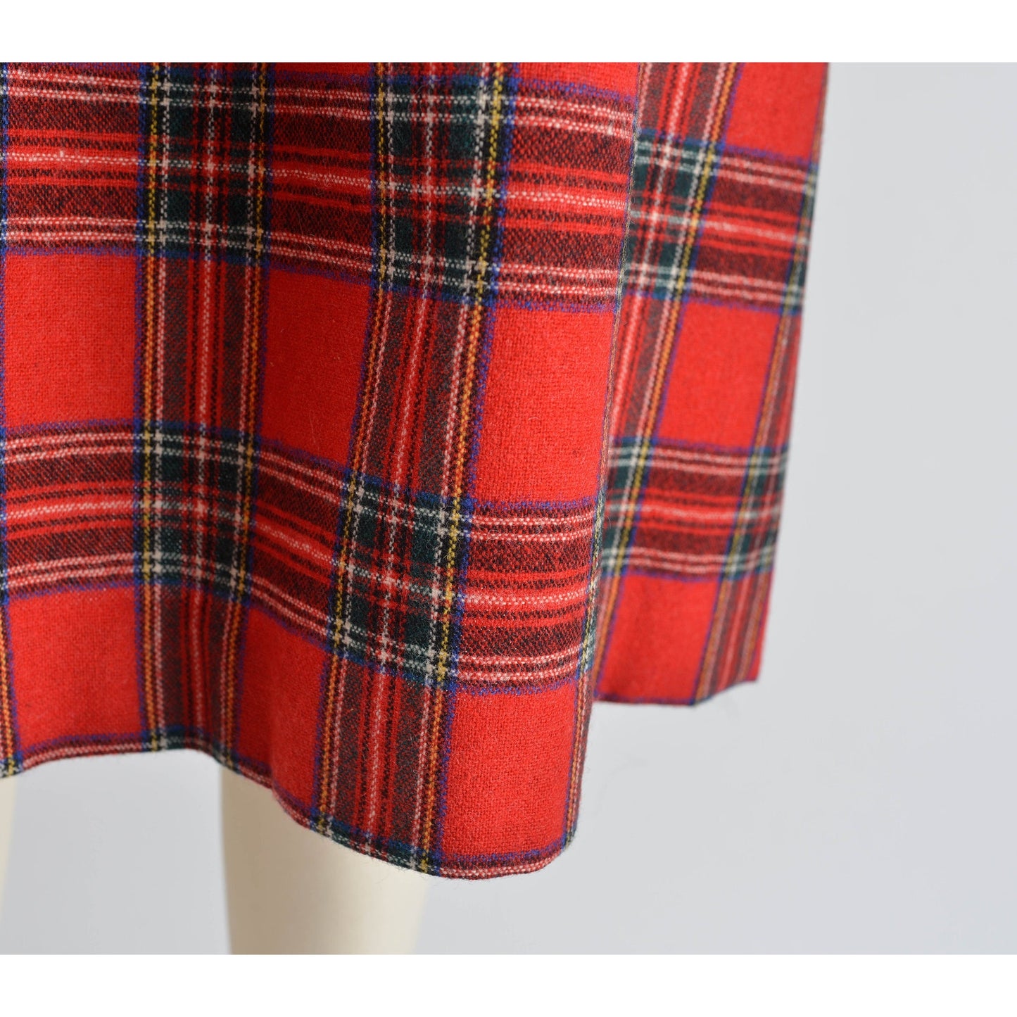 Close up view of Vintage 1970s red tartan plaid full wool midi skirt.