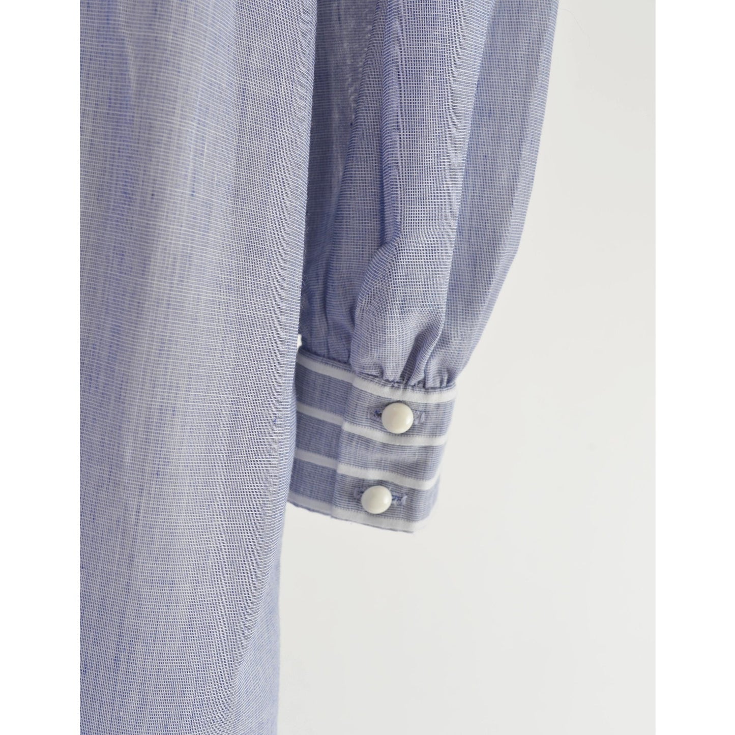 Close-up view of button closures on the sleeve's cuff.