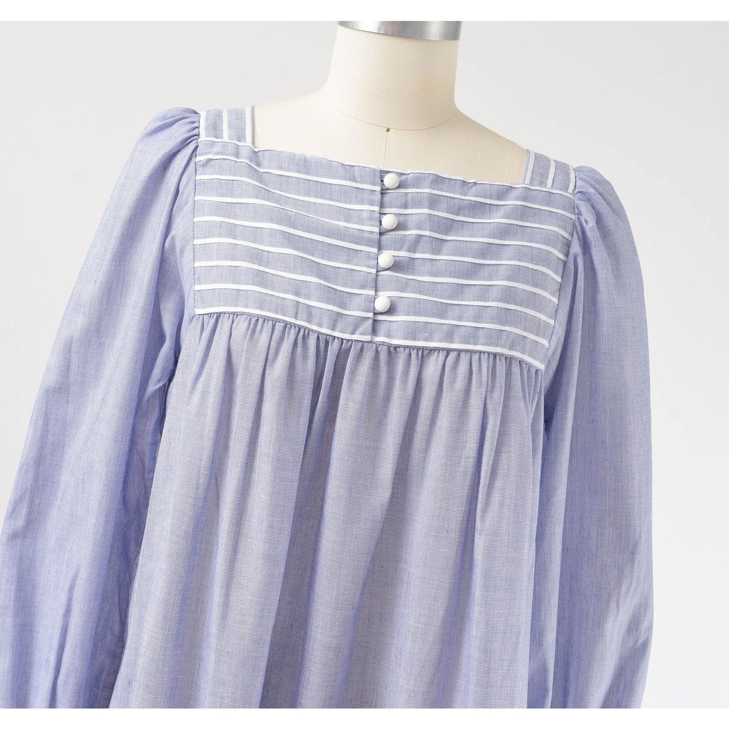 View of neckline on 80s blue and white striped cotton tent dress with puff sleeves. Front view.