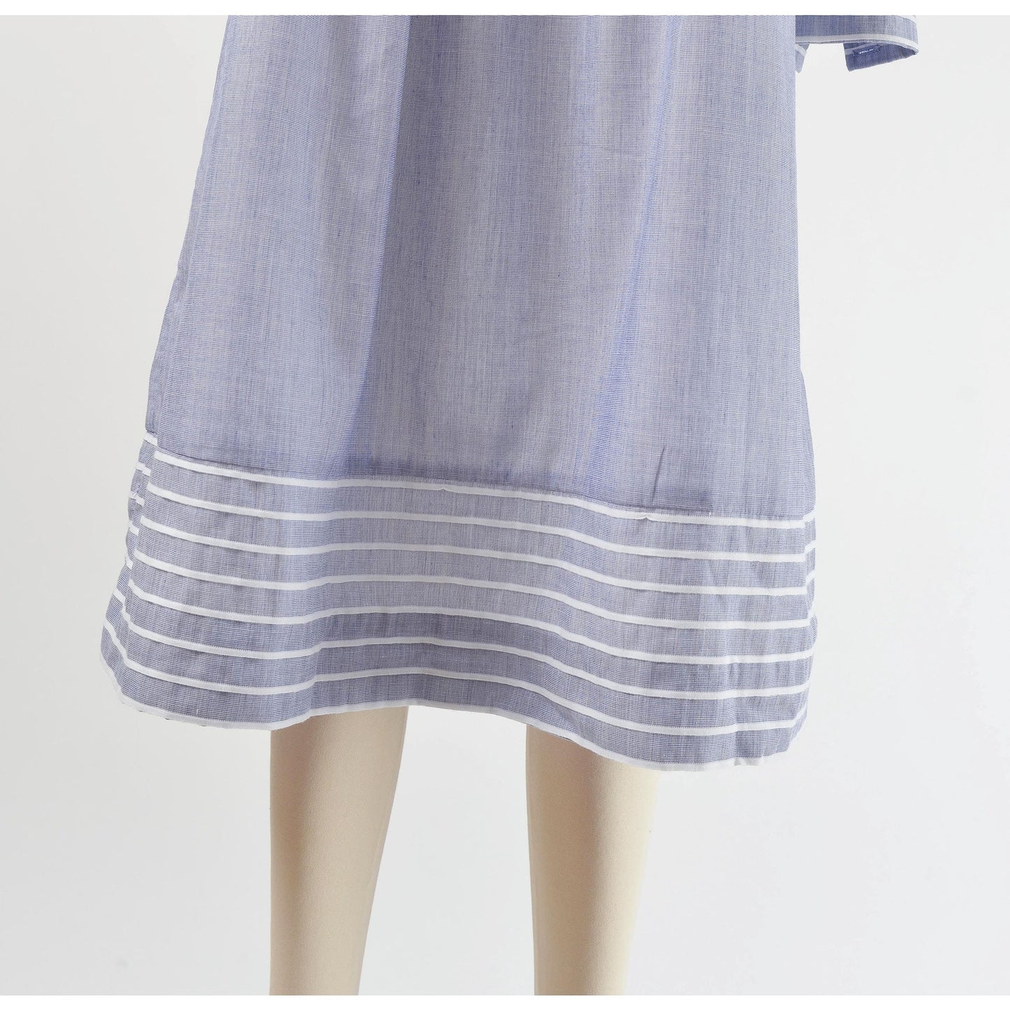 View of hemline on 80s blue and white striped cotton tent dress with puff sleeves. Front view.