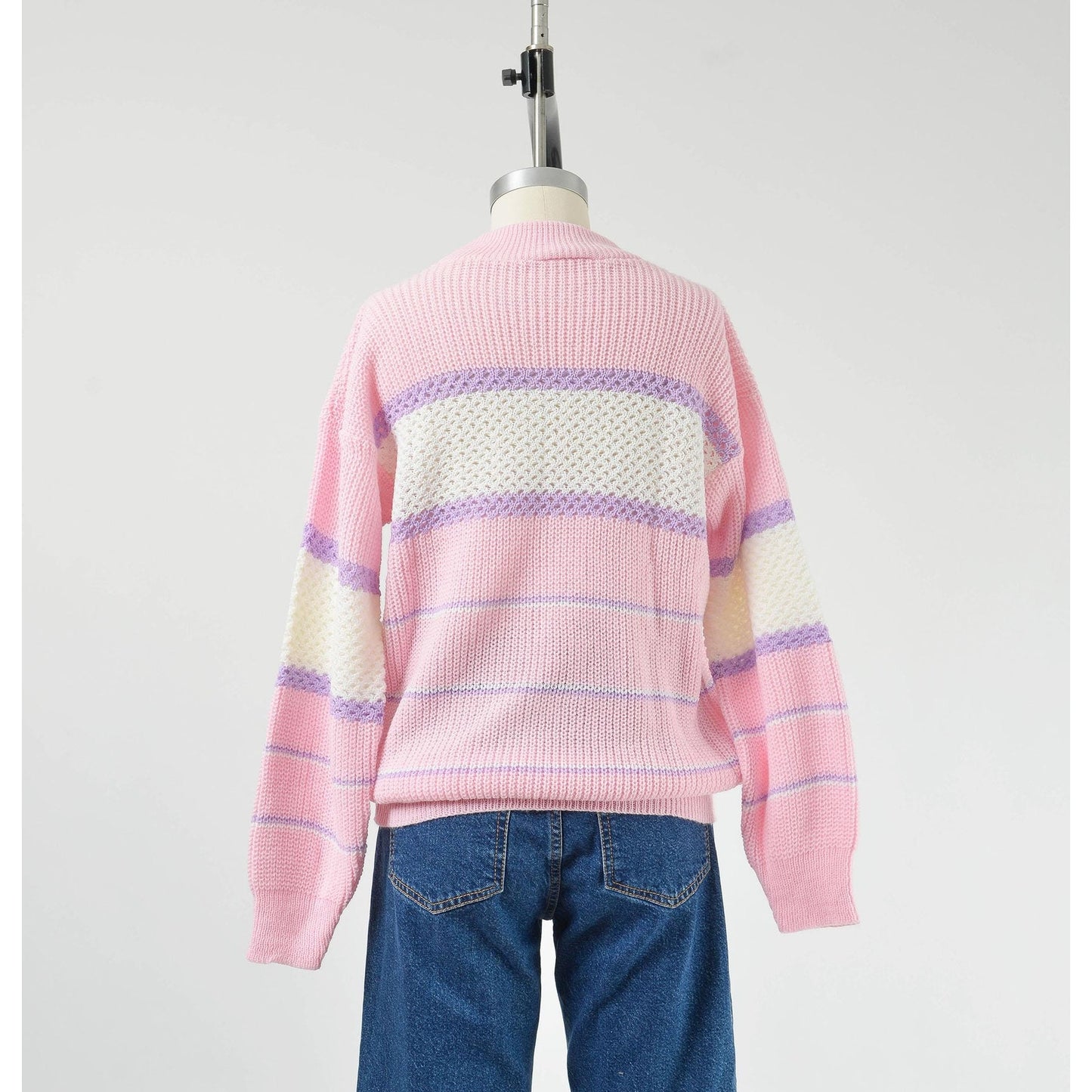 Back view of Vintage 1980s pink, white, and purple striped sweater with mock neck and slouchy fit.