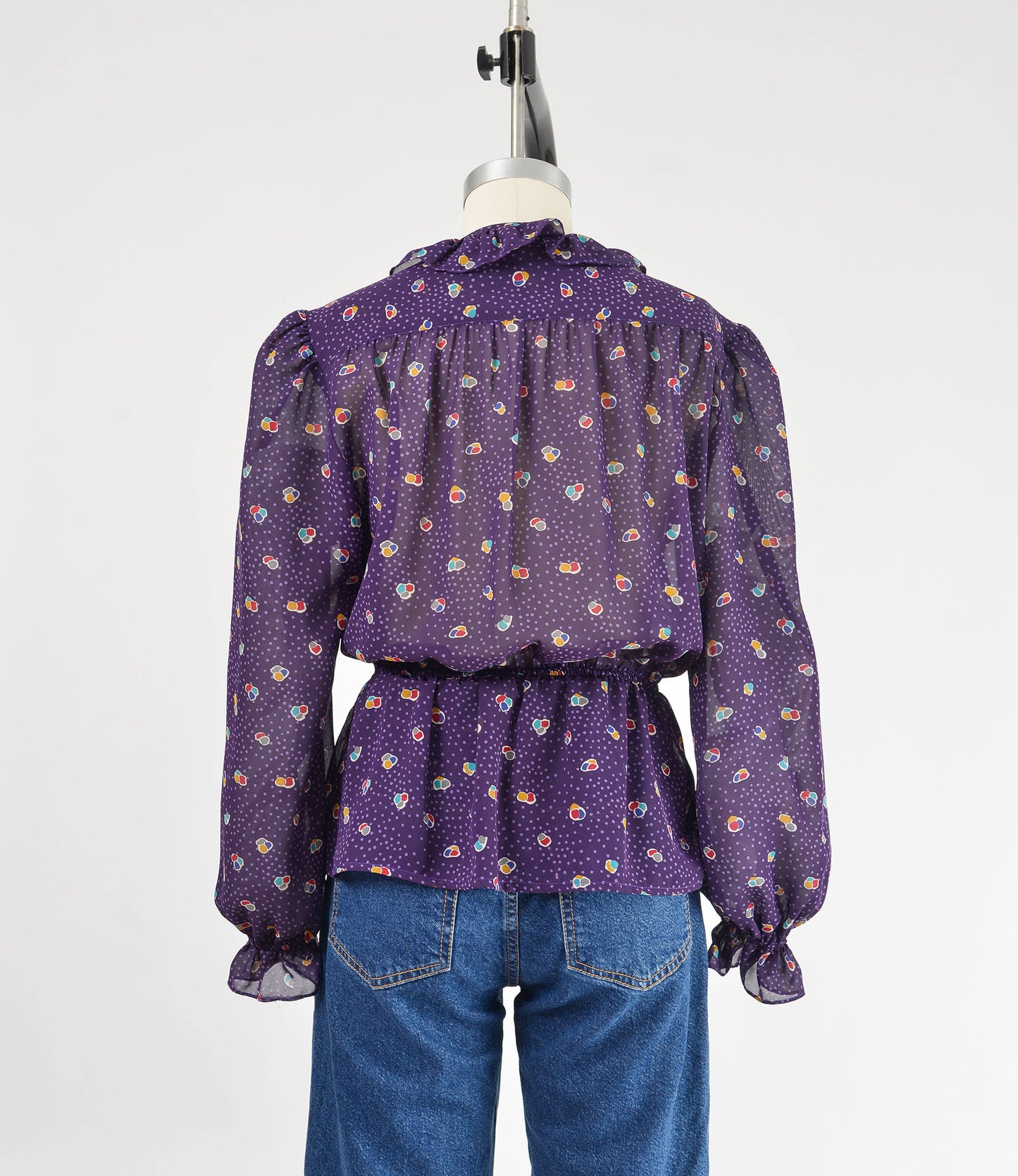 Vintage 80s sheer purple polka dot peplum waist tie neck blouse.