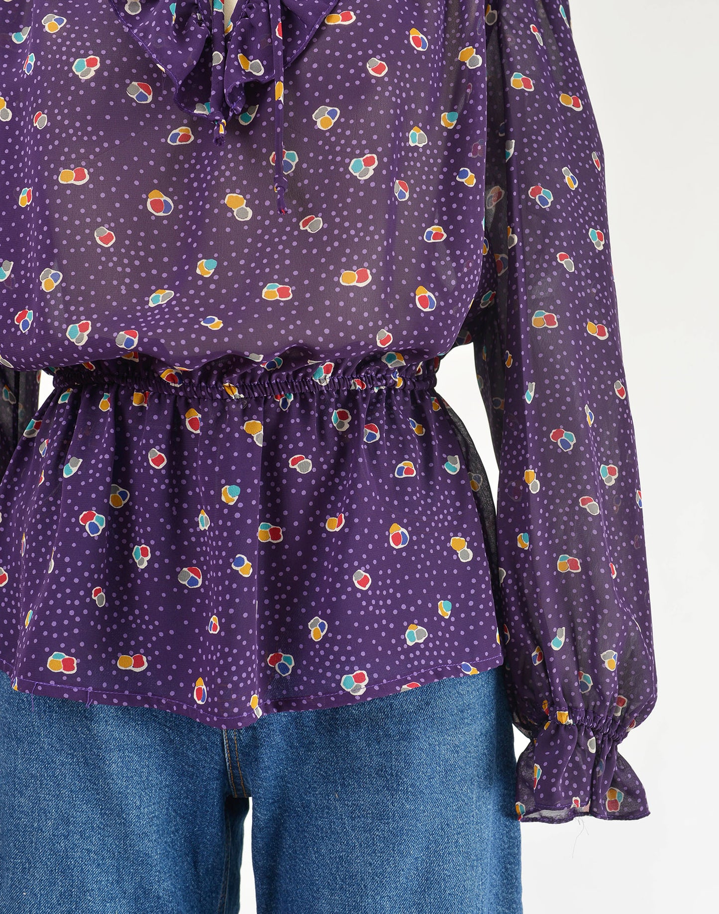 Vintage 80s sheer purple polka dot peplum waist tie neck blouse.
