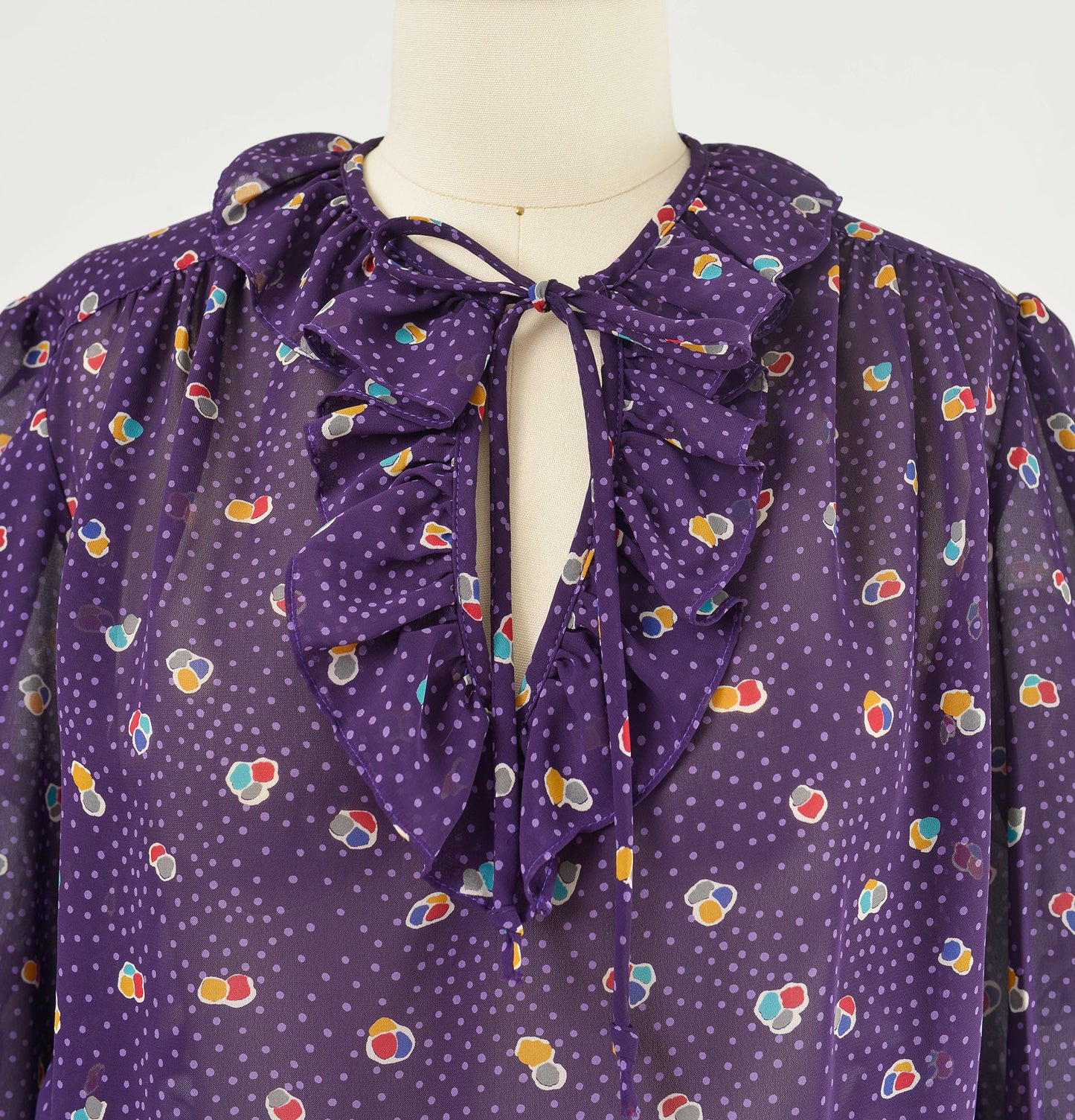 Vintage 80s sheer purple polka dot peplum waist tie neck blouse.