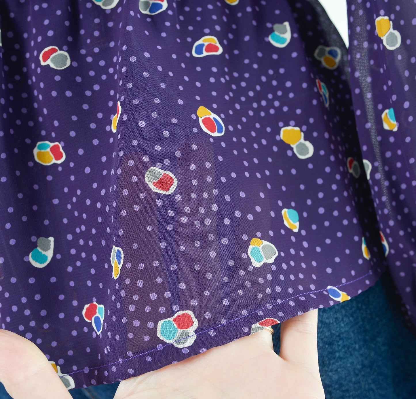 Vintage 80s sheer purple polka dot peplum waist tie neck blouse.