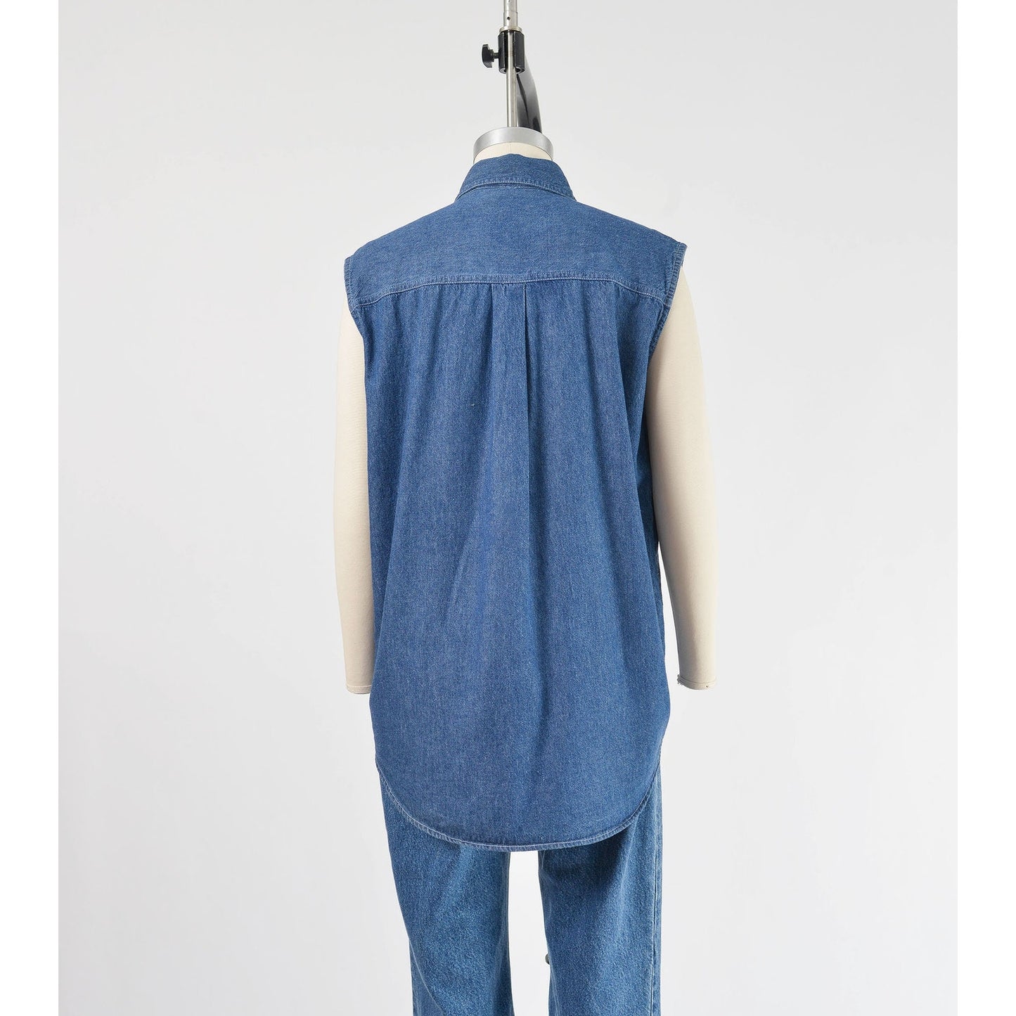 vintage 1990s denim cotton sleeveless collared shirt with rhinestones. Back view.