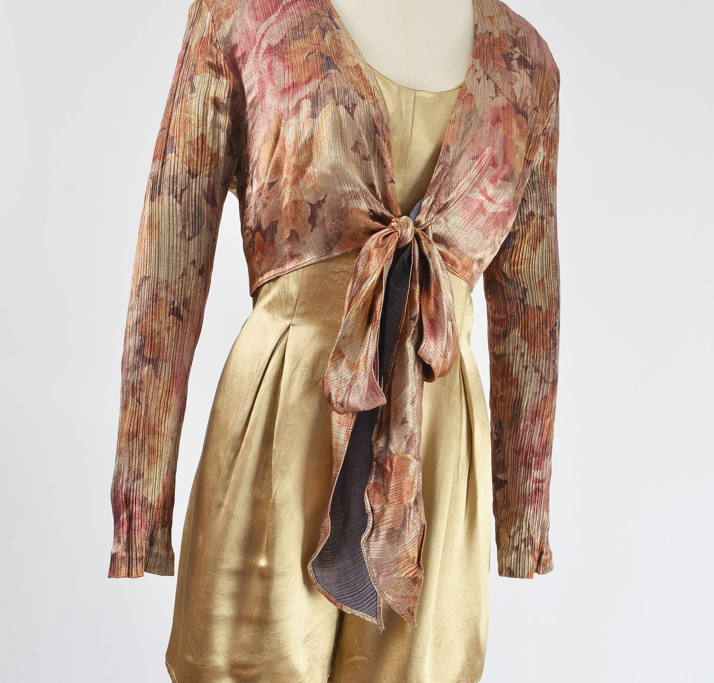 Close up of 1990s tan floral satin romper.