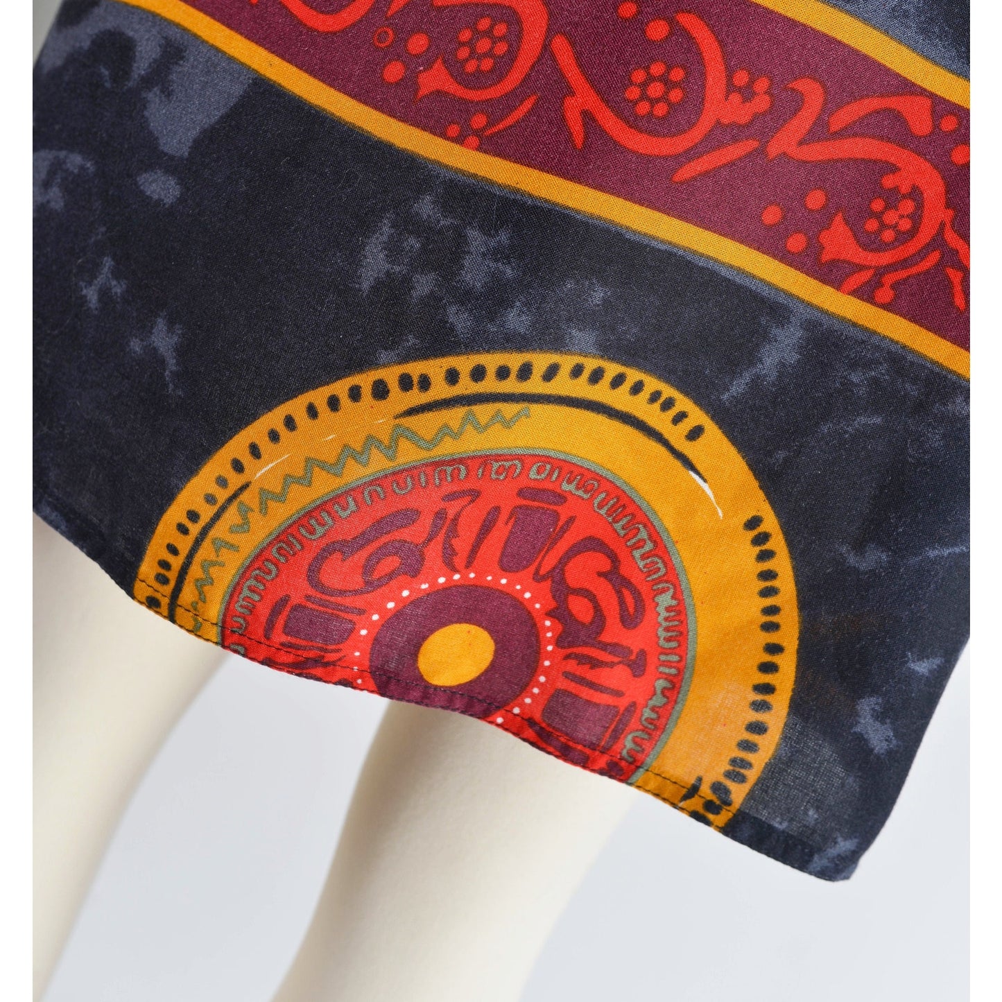 Close up view of fabric on vintage 90s ethnic Thai tank top and wrap around skirt two piece set.