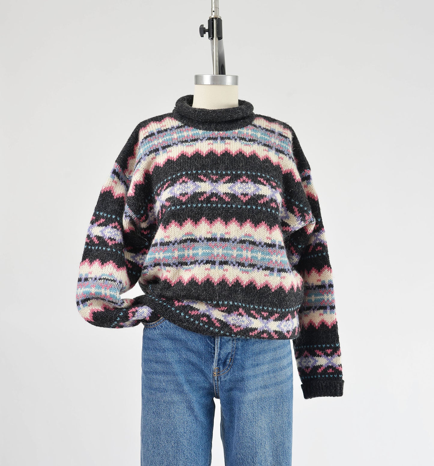 Front view of Woolrich sweater with sleeve tucked into pocket.
