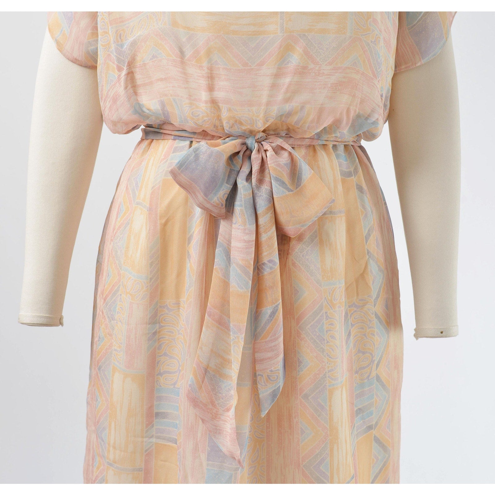 View of waistline and tie belt on Vintage 70s pastel geometric sheer chiffon blouson midi dress with tie belt. 