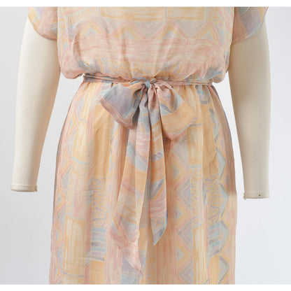 View of waistline and tie belt on Vintage 70s pastel geometric sheer chiffon blouson midi dress with tie belt. 