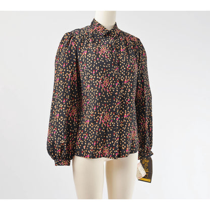 Side view of 70s black spotted blouse. Matte silky fabric. Collared neckline with long puff sleeves. 