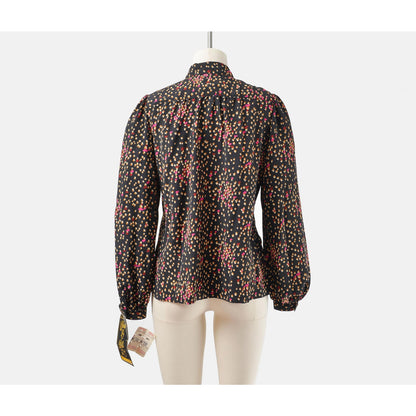 Back view of 70s black spotted blouse. Matte silky fabric. Collared neckline with long puff sleeves. 