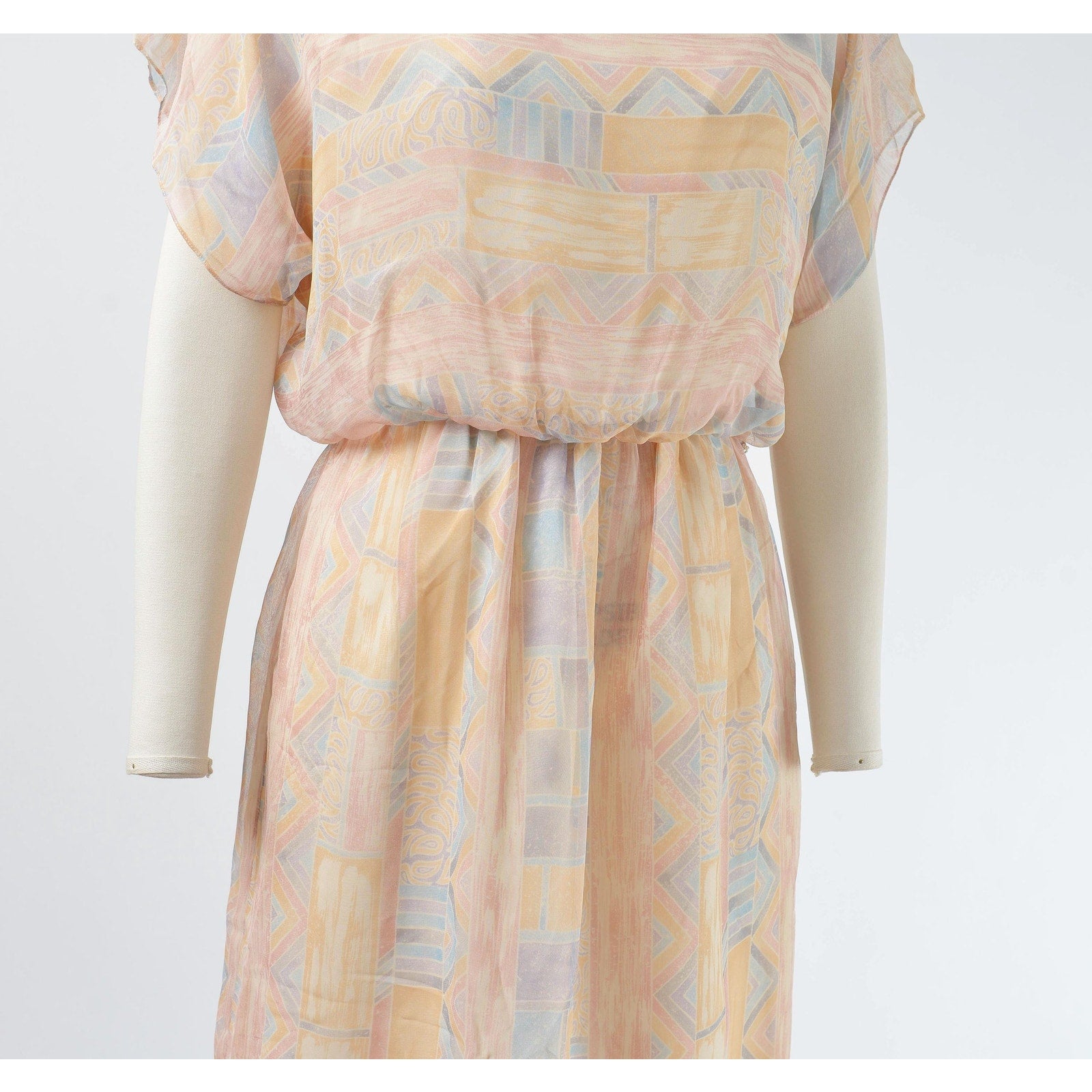 Side view of waistline on 70s geometric chiffon dress. 