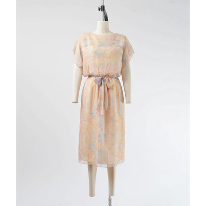 Front view of Vintage 70s pastel geometric sheer chiffon blouson midi dress with tie belt. 