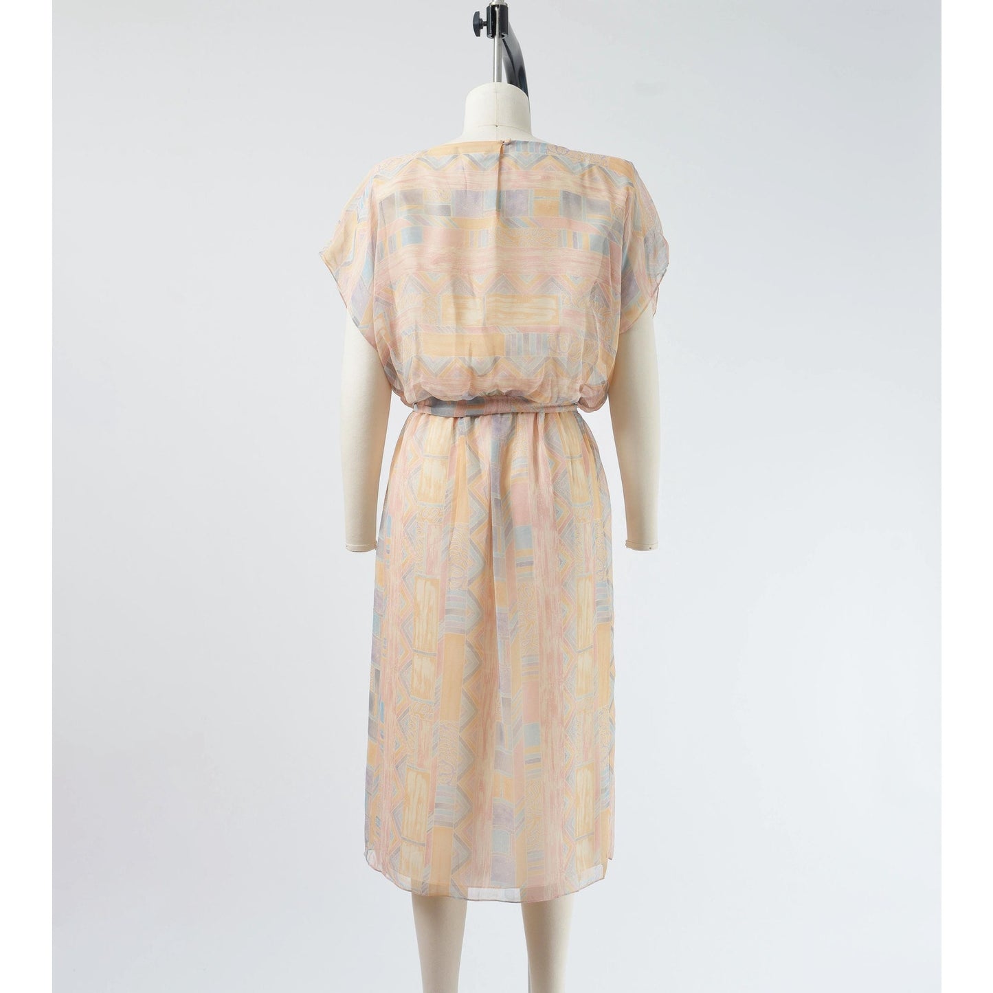 Back view of Vintage 70s pastel geometric sheer chiffon blouson midi dress with tie belt. 