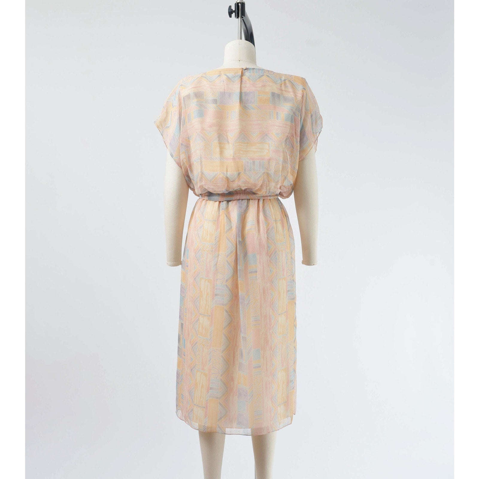 Back view of Vintage 70s pastel geometric sheer chiffon blouson midi dress with tie belt. 