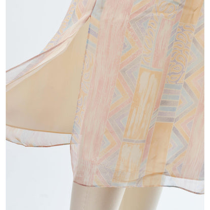 View of slit on the vintage 70s pastel geometric sheer chiffon blouson midi dress with tie belt. 