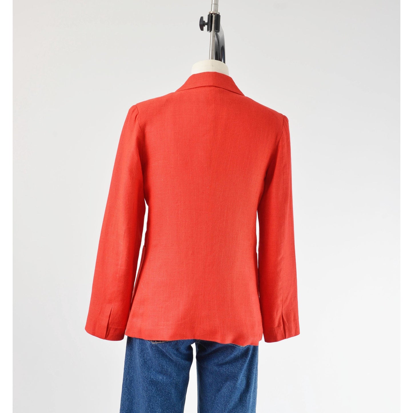 Back view of Vintage 1970s red linen and rayon blend blazer. Fitted silhouette. Two button closures with large hip pockets. 