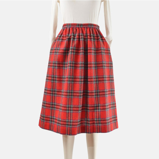 Front view of a 70s vintage red plaid wool midi skirt with pockets. 