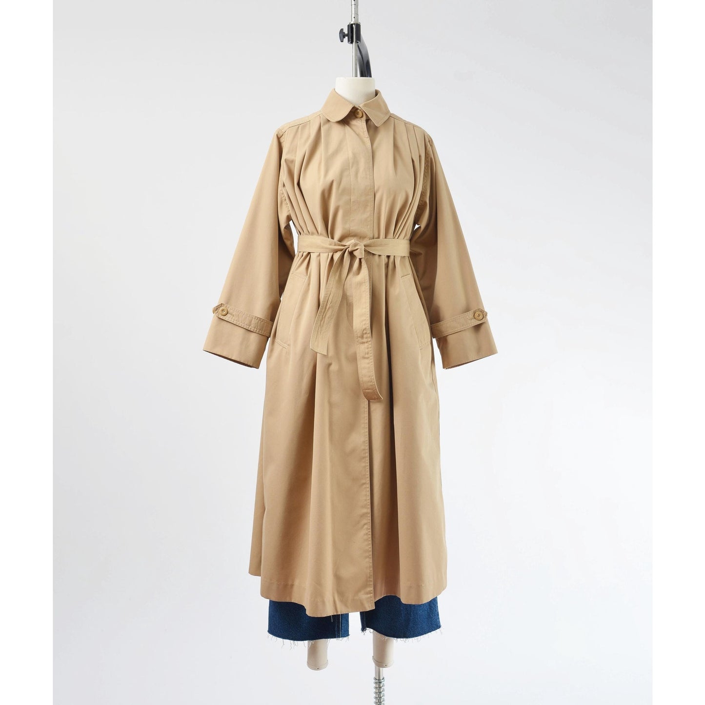 Belted full frontal view of a vintage 1970's tan trench coat. 