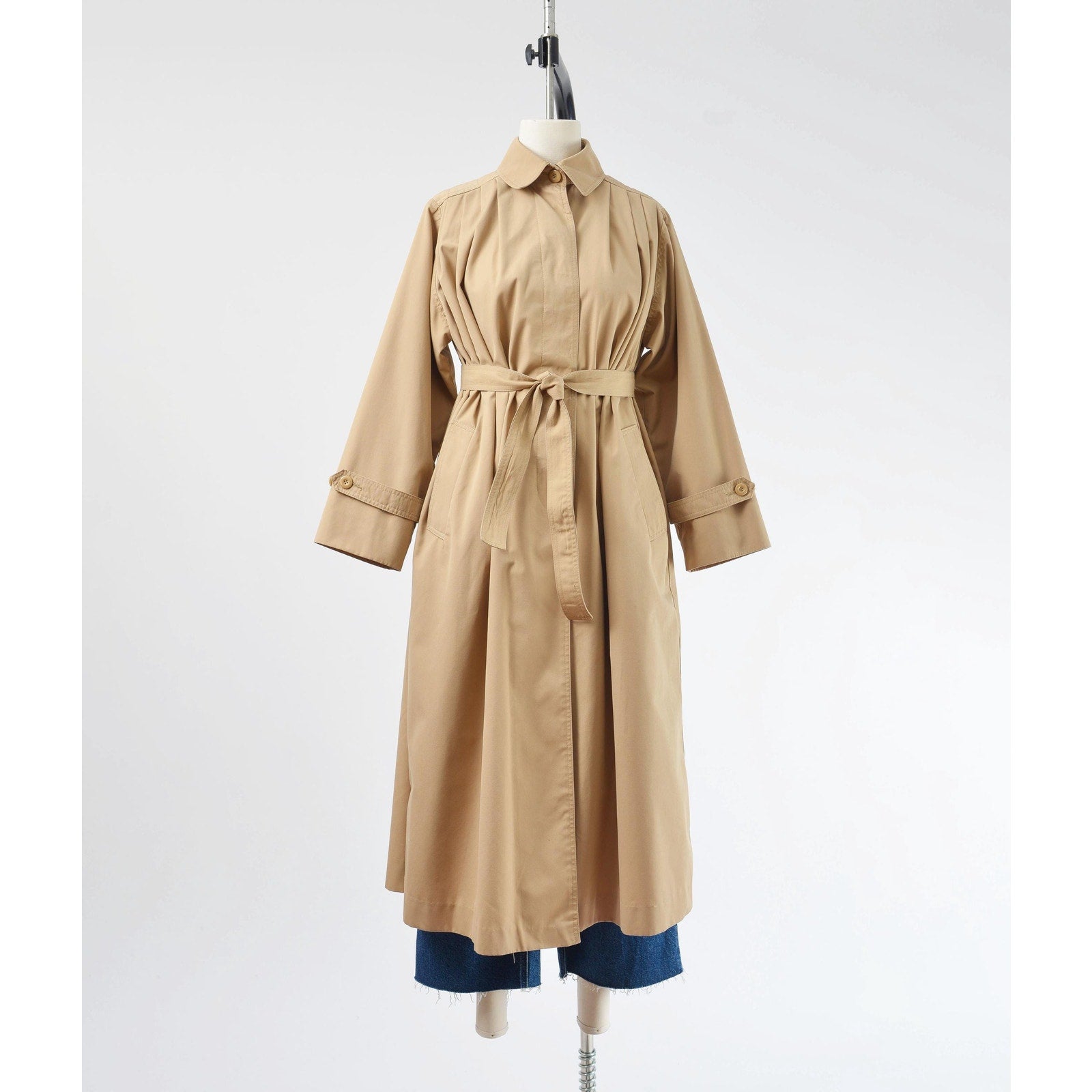 Belted full frontal view of a vintage 1970's tan trench coat. 