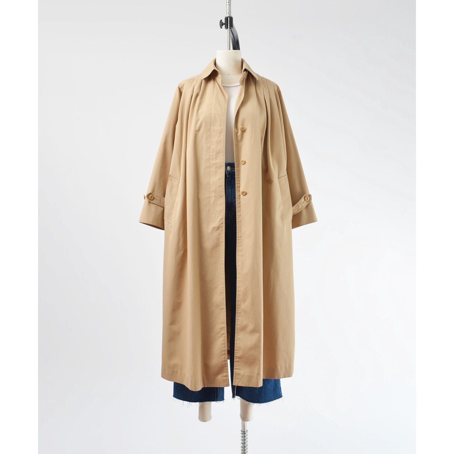 Full unbutton view of a 1970's tan trench coat.