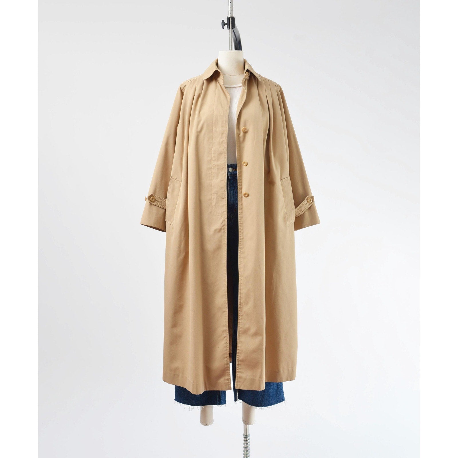 Full unbutton view of a 1970's tan trench coat.