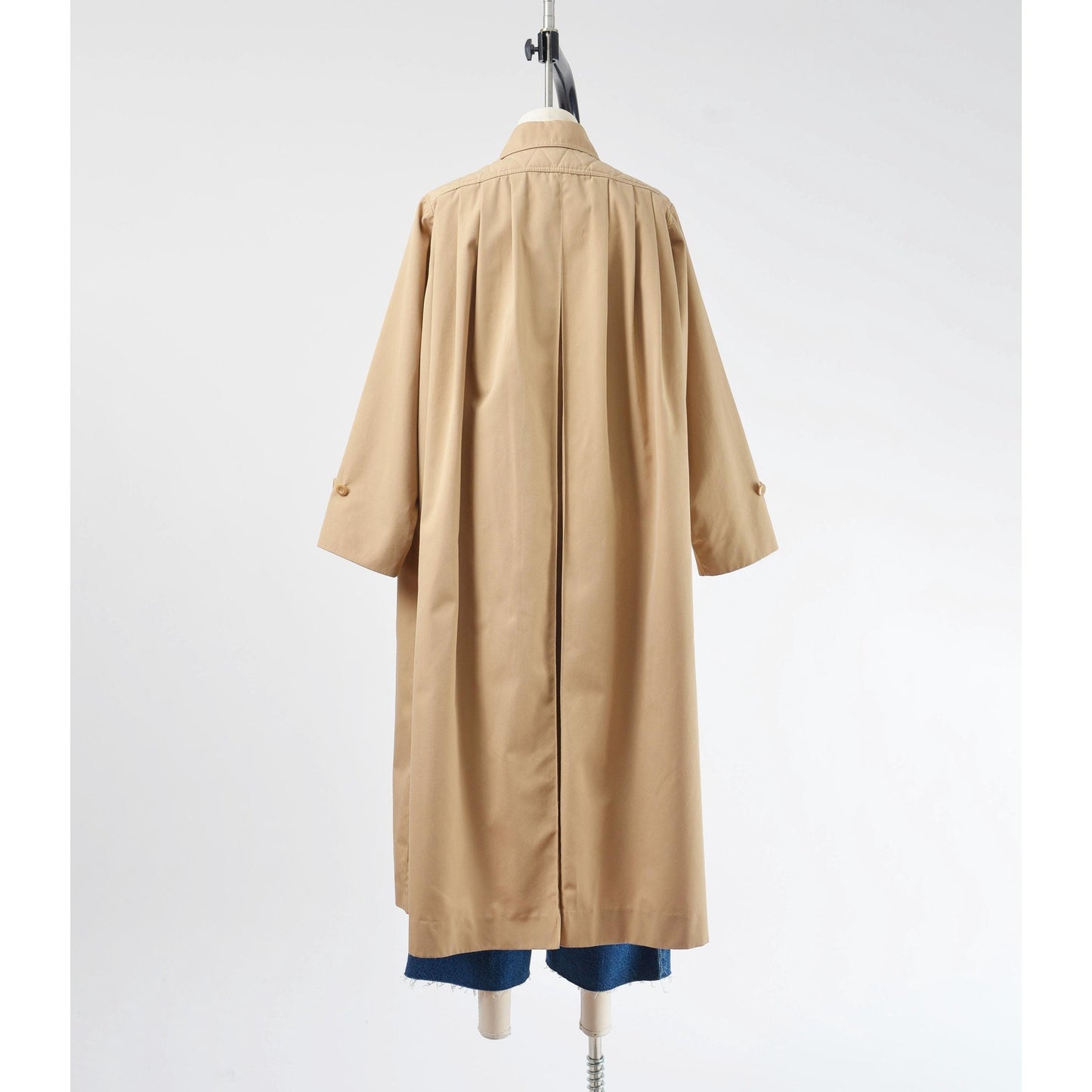 Back view of 70's tan trench coat. Unbelted with full swing silhouette. 