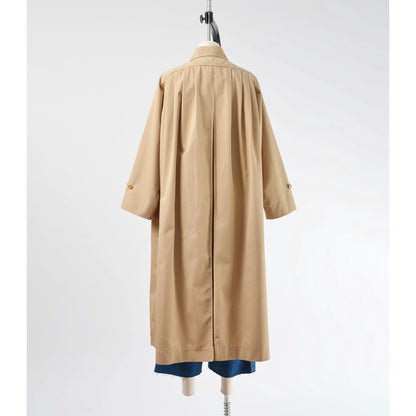 Back view of 70's tan trench coat. Unbelted with full swing silhouette. 