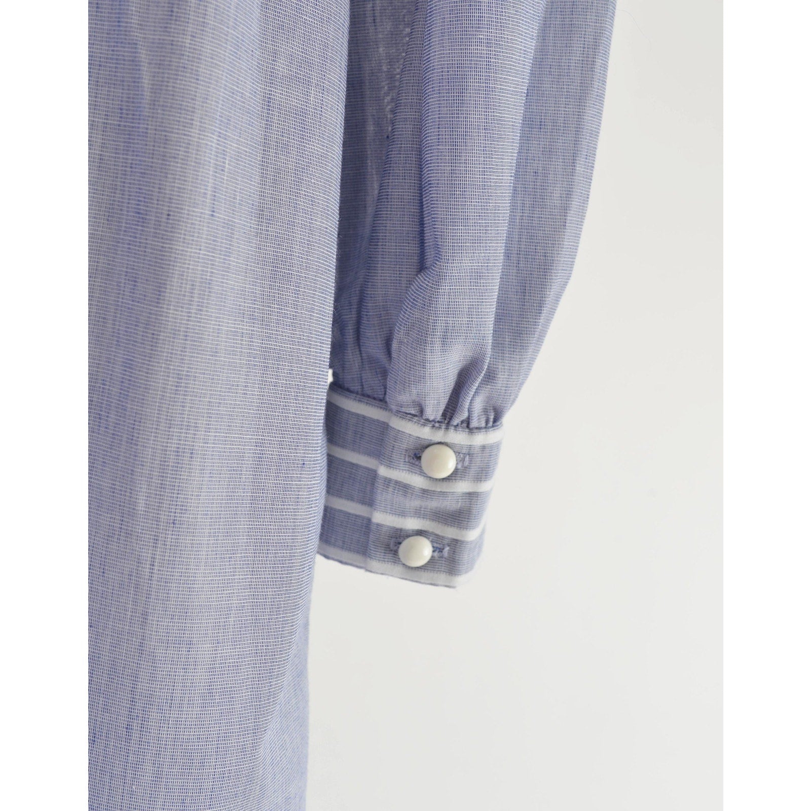 Close-up view of button closures on the sleeve's cuff.