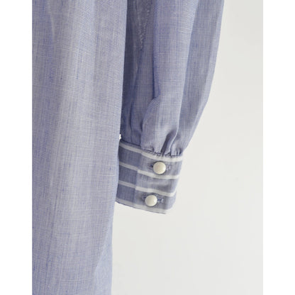 Close-up view of button closures on the sleeve's cuff.