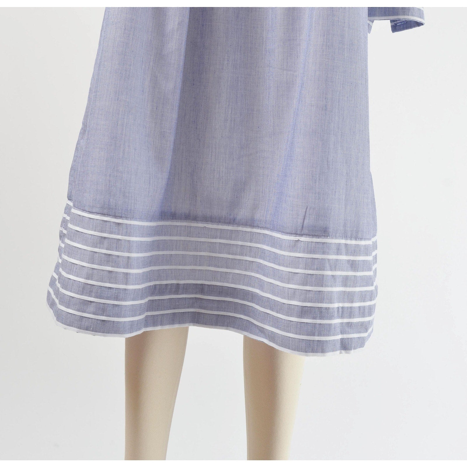View of hemline on 80s blue and white striped cotton tent dress with puff sleeves. Front view.  