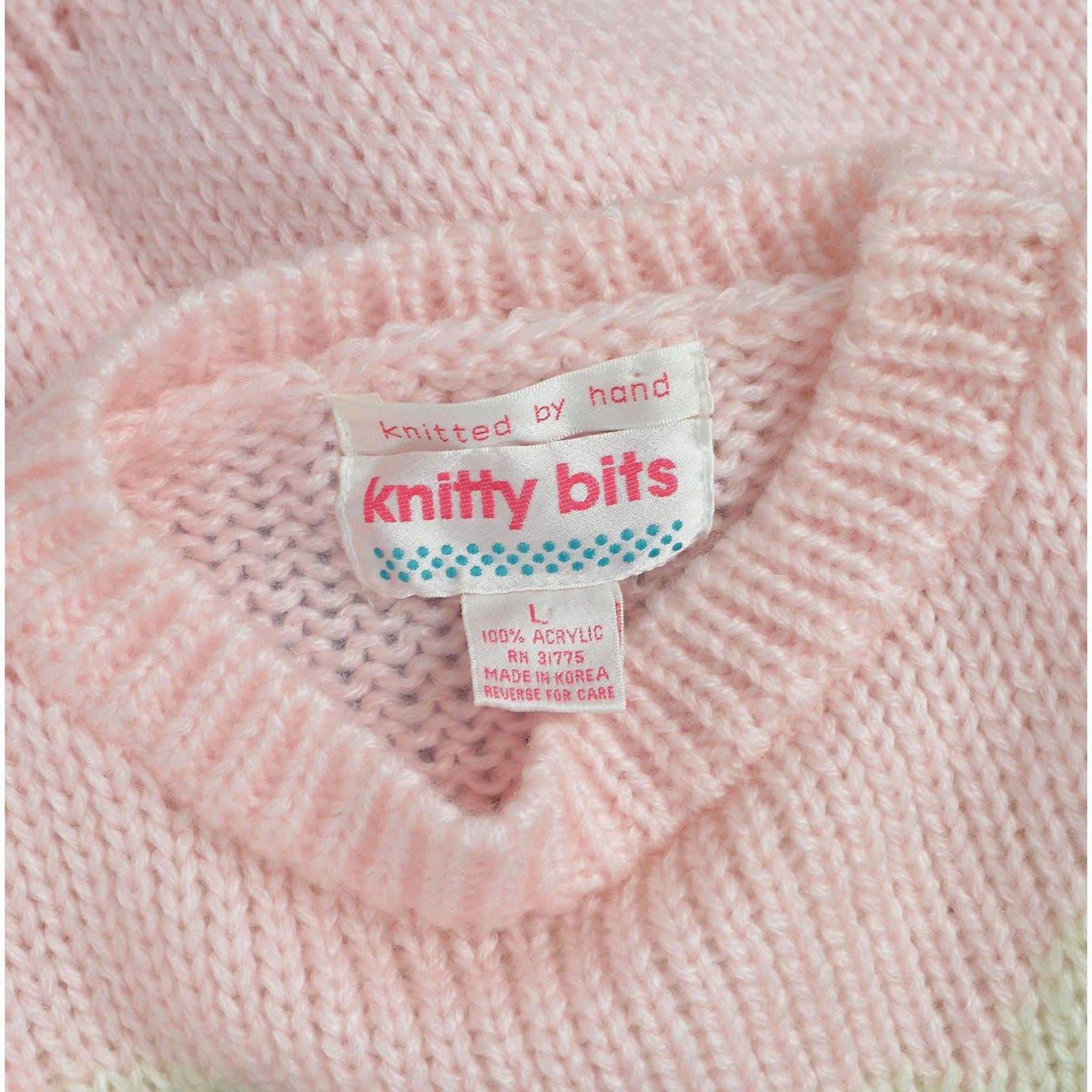 View of label Knitty Bits. Vintage 1980s kawaii pink teddy bear sweater. Chunky acrylic knit. 