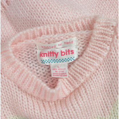 View of label Knitty Bits. Vintage 1980s kawaii pink teddy bear sweater. Chunky acrylic knit. 