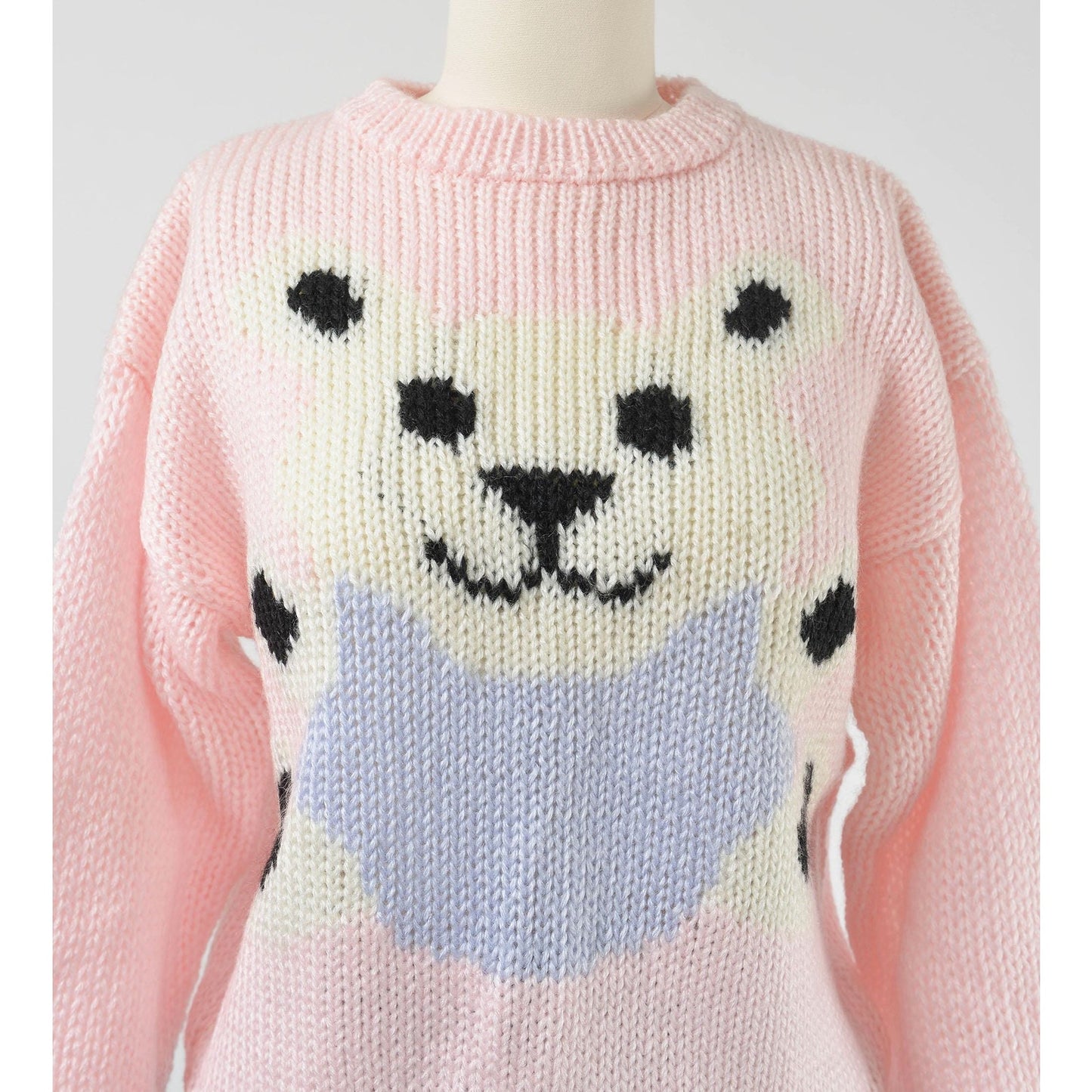 Vintage 1980s kawaii pink teddy bear sweater. Chunky acrylic knit. Close up view.