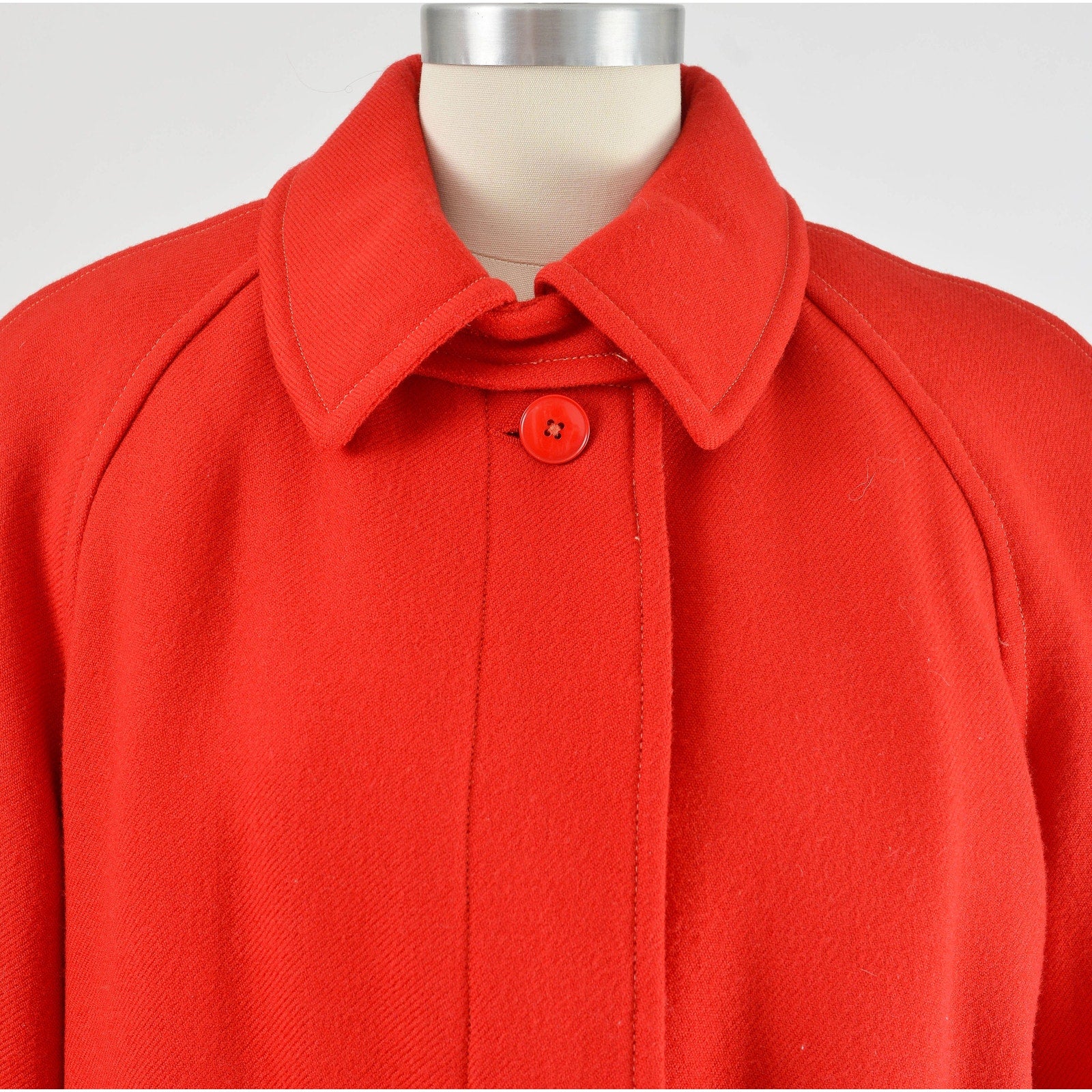 Close up view of neckline on vintage 80s red wool long full length winter coat. 