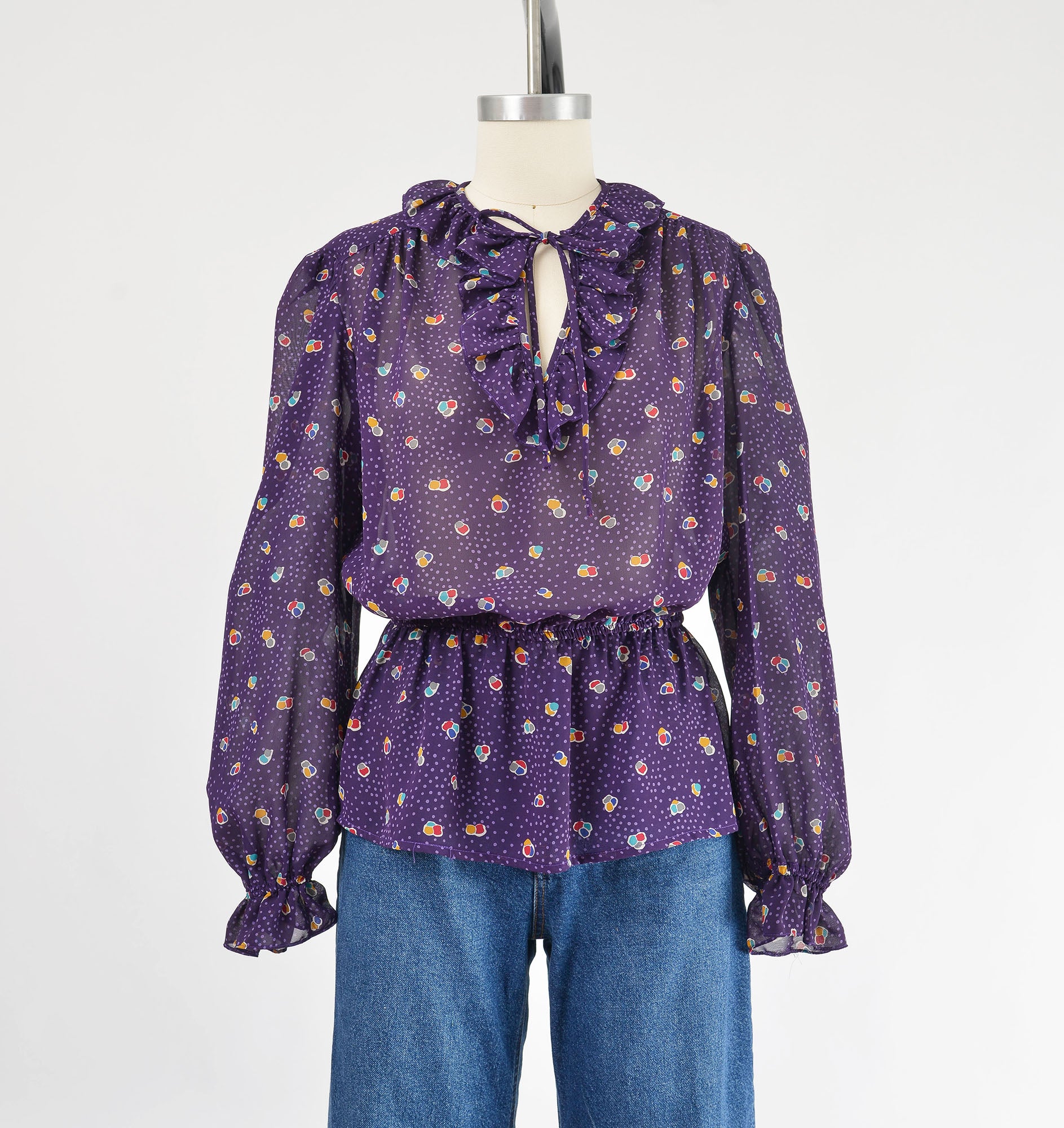 Vintage 80s sheer purple polka dot peplum waist tie neck blouse. 