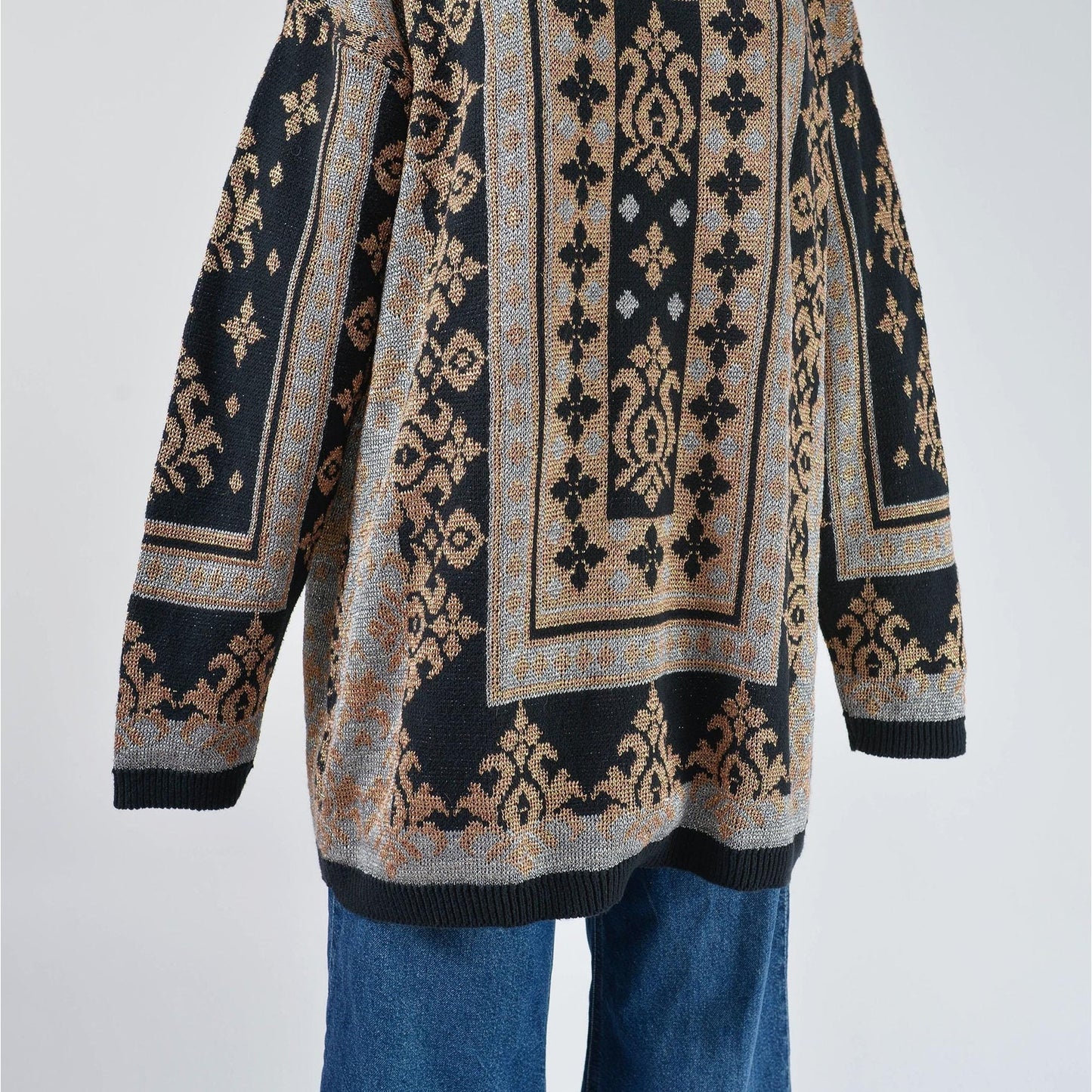 Vintage 90s black metallic baroque oversized pullover sweater. Hemline view.