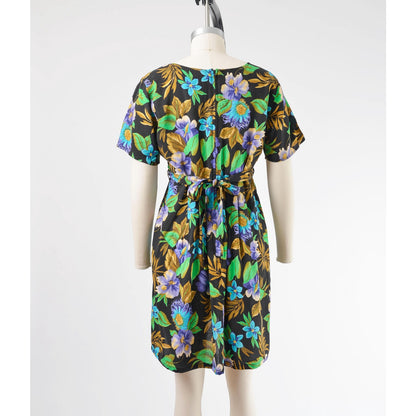 Full back view of vintage 90's floral Hawaiian print babydoll dress. Rear zipper closure with waist ties. 