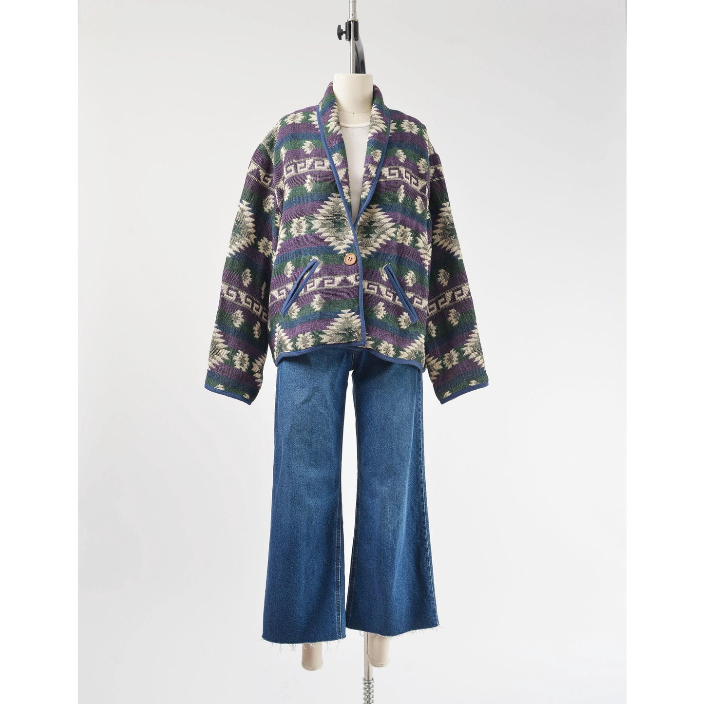 Full front view of vintage 90s southwestern woven cotton jacket. Styled with a pair of wide leg jeans. 