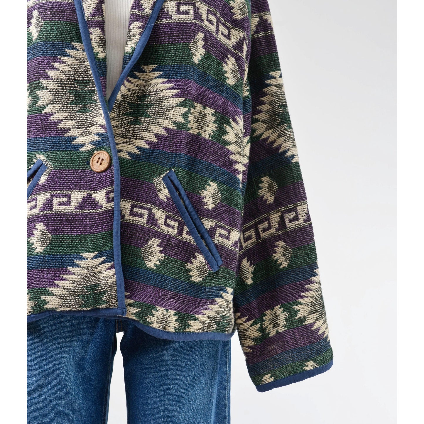 Close up view of pocket on southwestern jacket. 