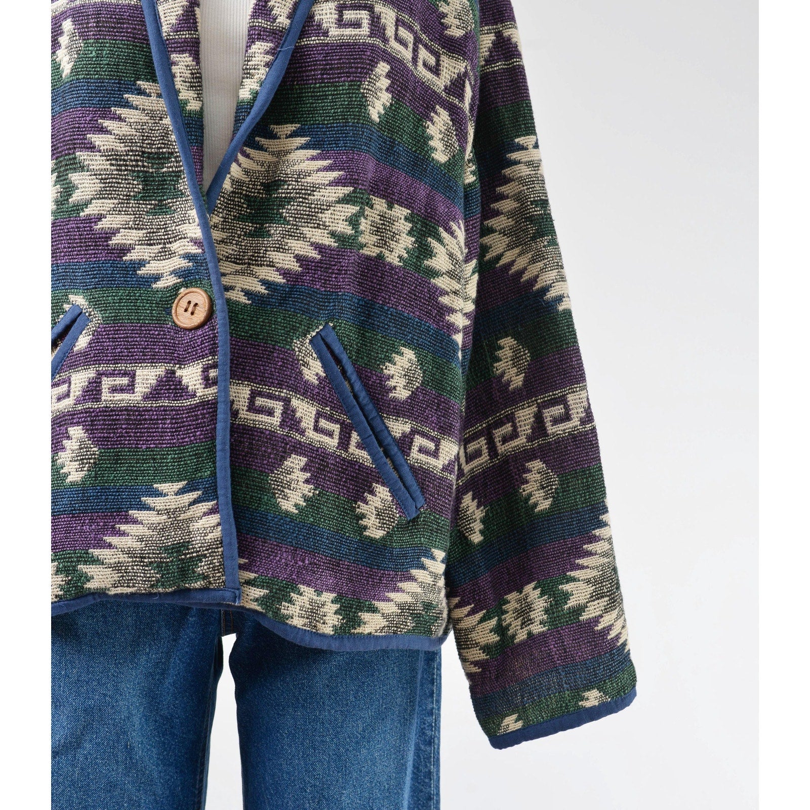 Close up view of pocket on southwestern jacket. 