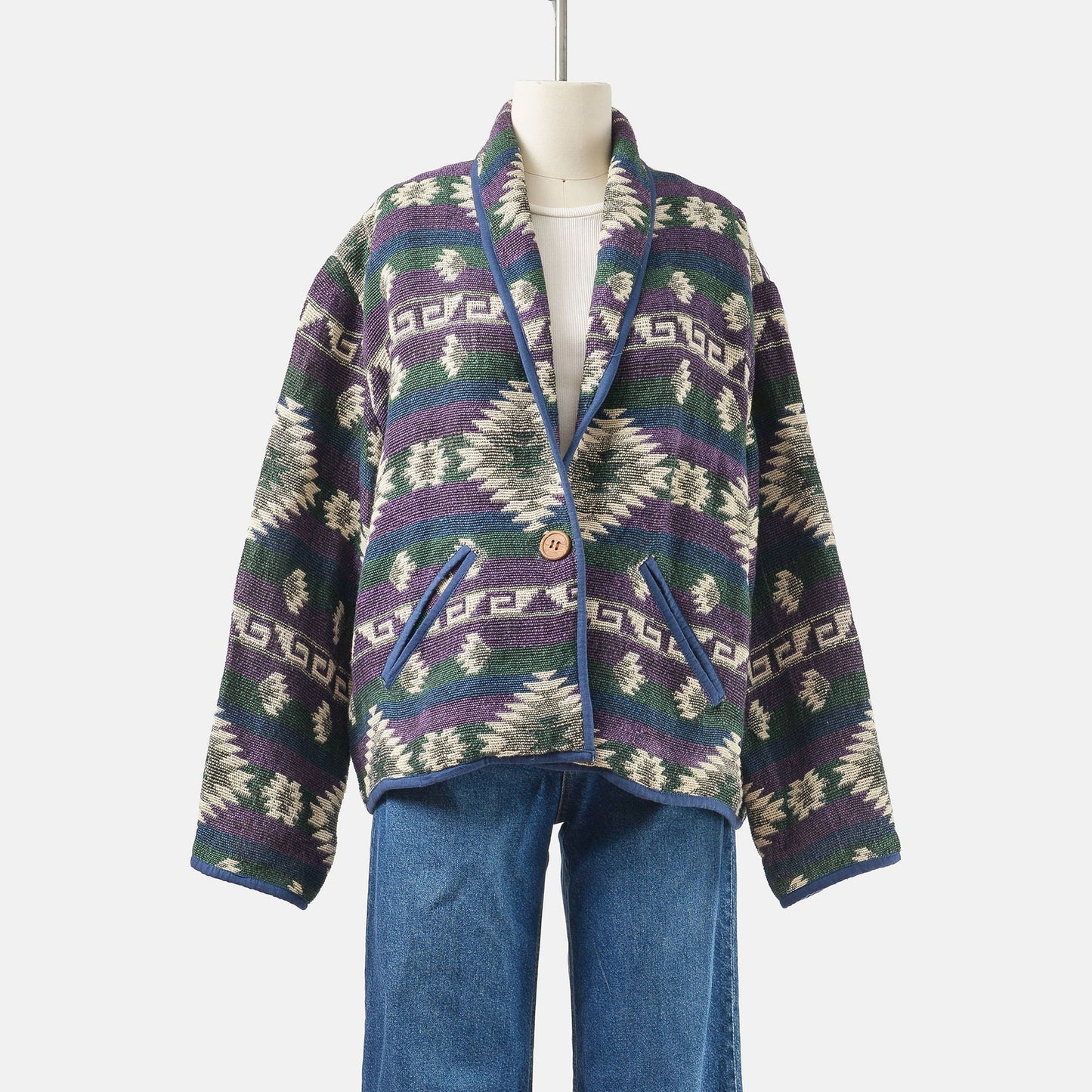 Front view of vintage 90's woven cotton southwestern jacket with pockets and single button closure. 