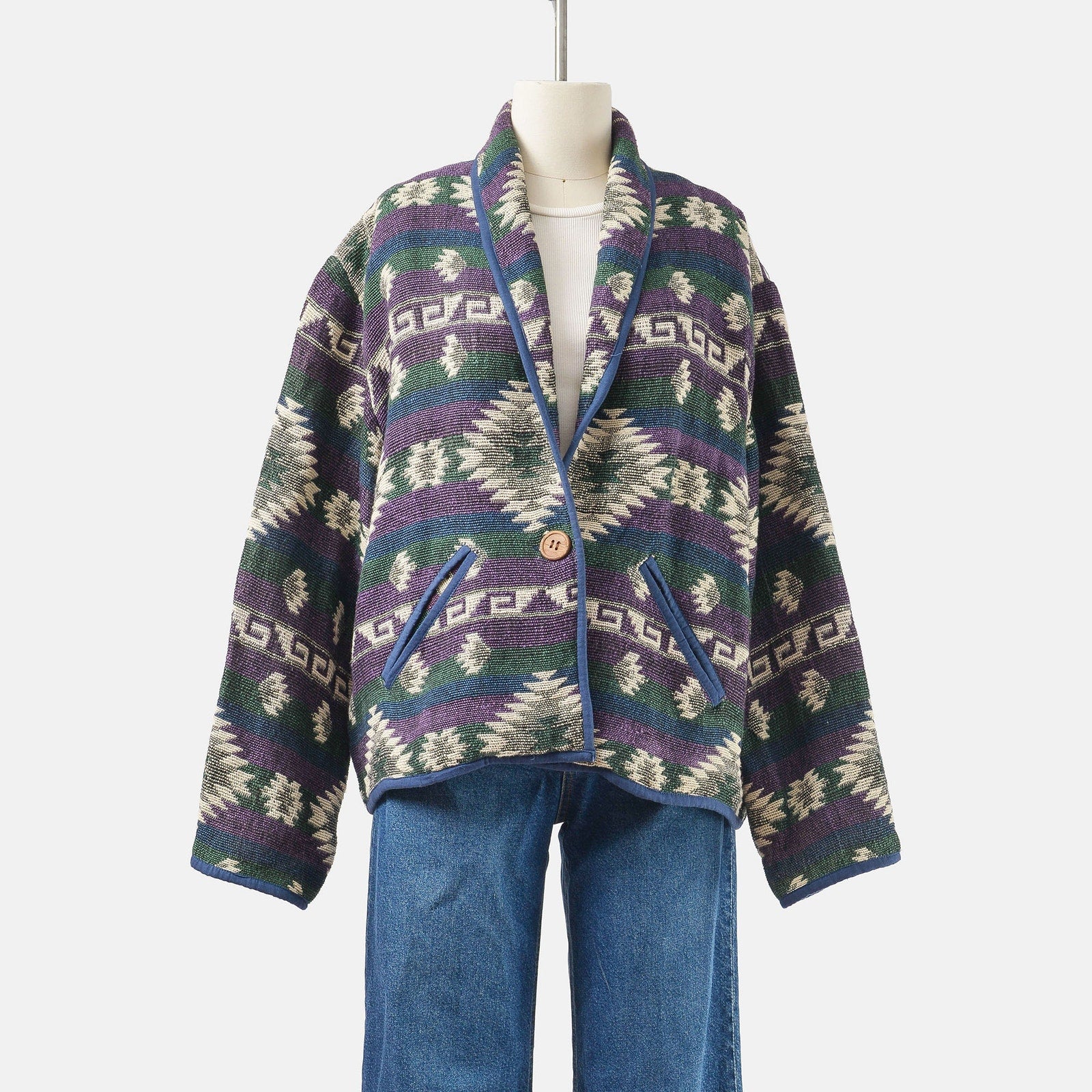 Front view of vintage 90's woven cotton southwestern jacket with pockets and single button closure. 